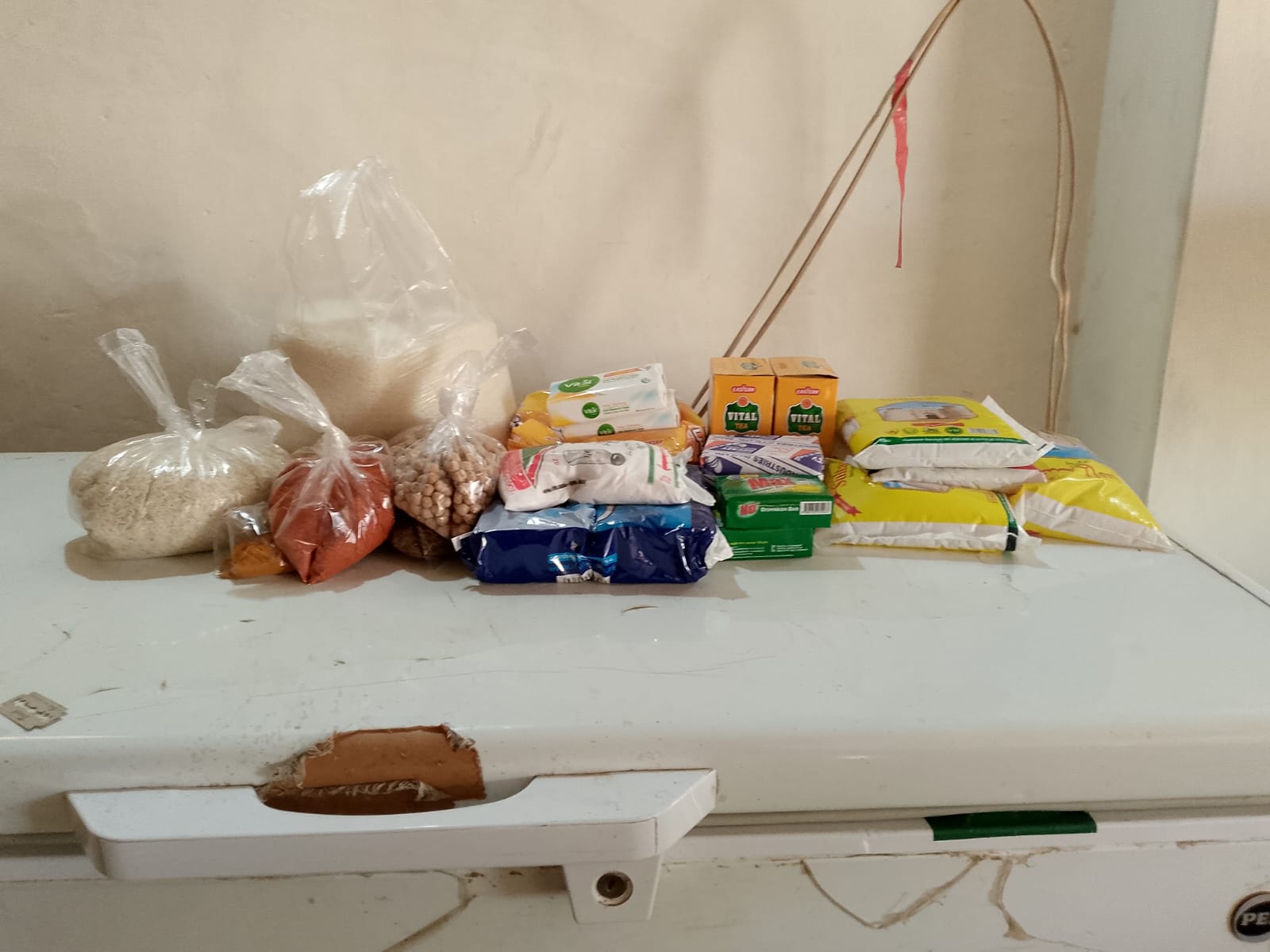 Essential food ration contents including rice, flour, pulses, oil, tea, and hygiene items provided by Fatima Hope Foundation.