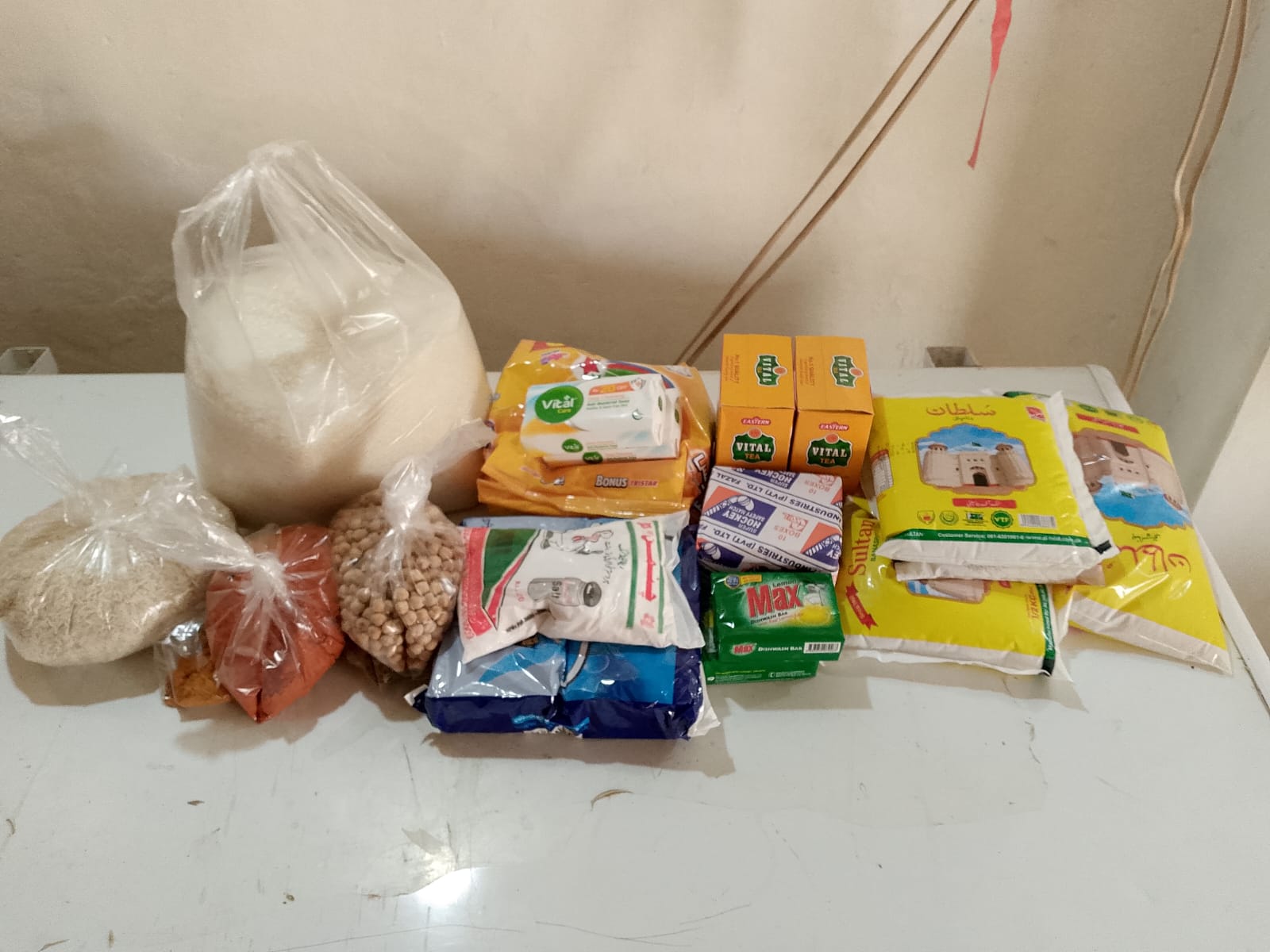 Essential food ration contents including rice, flour, pulses, oil, tea, and hygiene items provided by Fatima Hope Foundation.