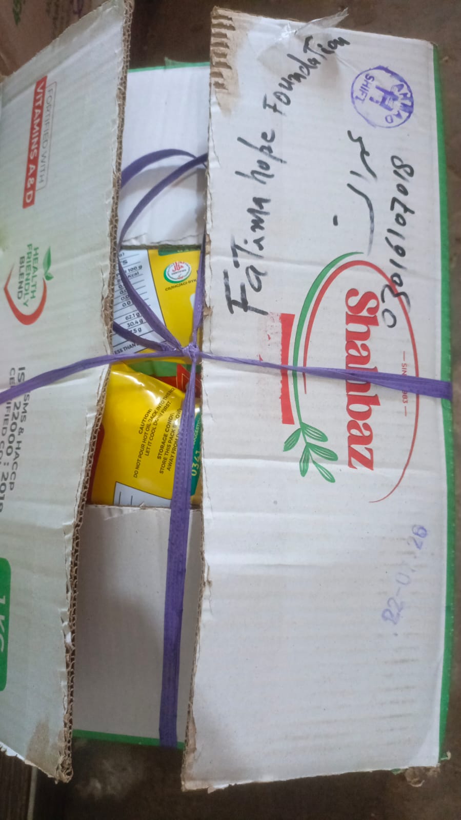 Sealed and labeled food ration donation boxes prepared by Fatima Hope Foundation for relief distribution.
