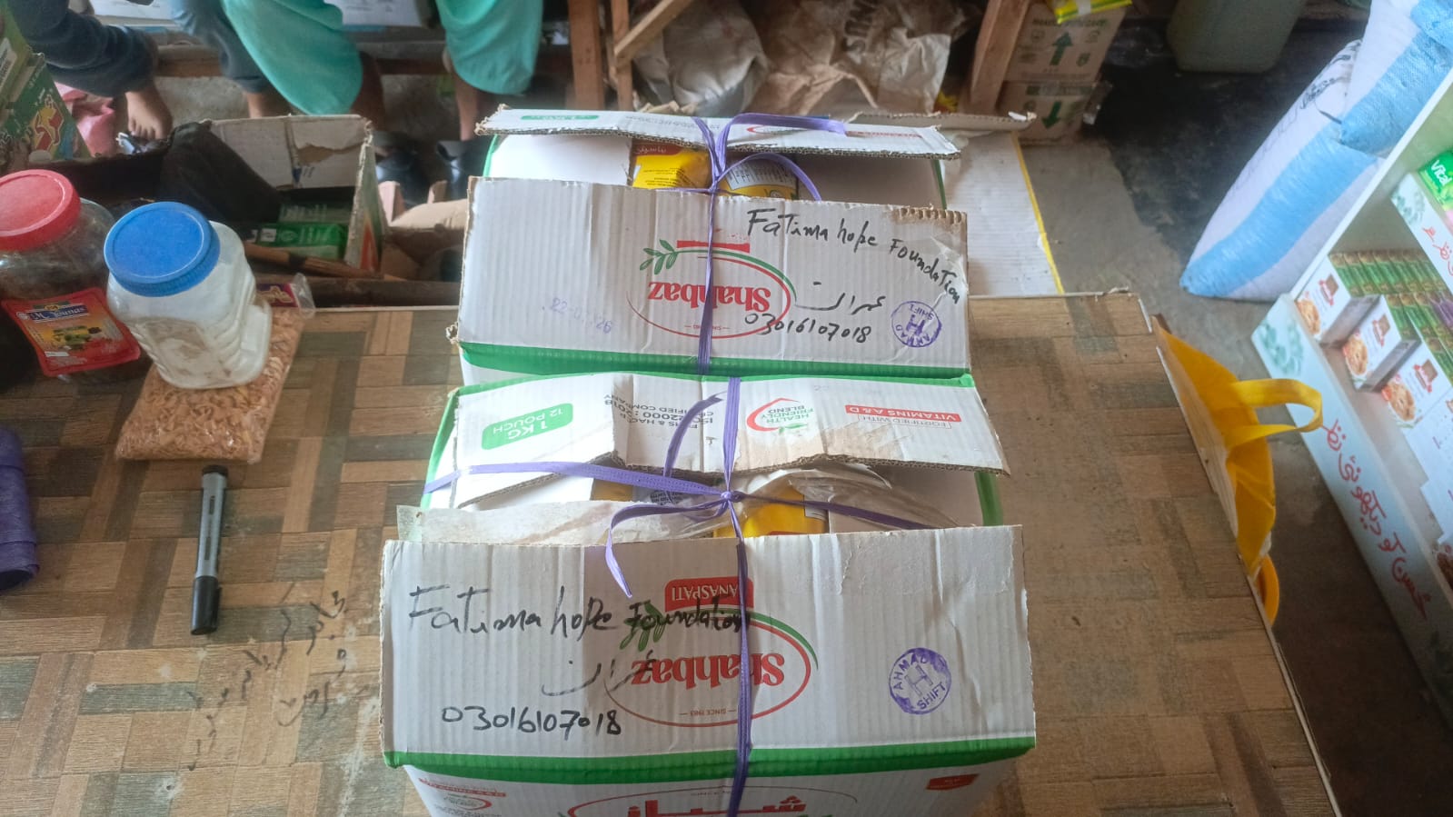 Sealed and labeled food ration donation boxes prepared by Fatima Hope Foundation for relief distribution.